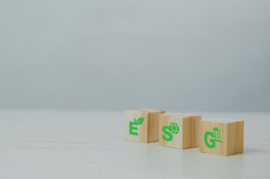 Wooden cubes with ESG Environmental Social Governance symbol on background and copy space.Business concepts.