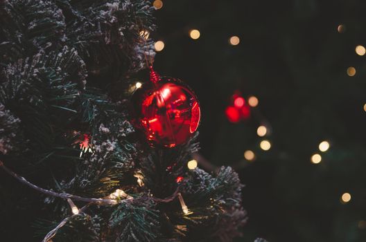 Christmas tree decorations with lights and red balls. Vintage tone copy space.