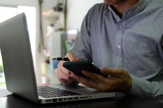 Businessman using mobile and computers are working on searching for information using internet technology.Modern concepts, business communication, investment and online marketing.