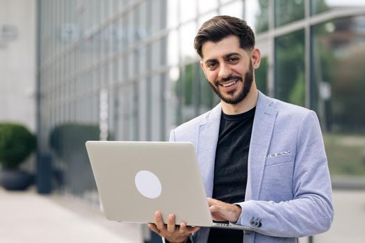 Handsome bearded businessman professional financial advisor, executive leader, manager, male lawyer or man entrepreneur standing in office posing for headshot business portrait.