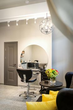 Interior of empty modern hair and beauty salon in lights tones