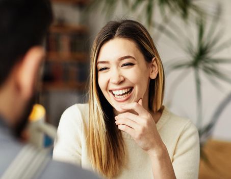 Portrait of a young happy girl talking with a friend