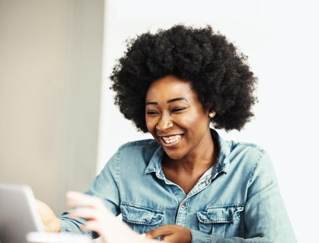 Attractive african american business woman in a modern office or a student in a classroom