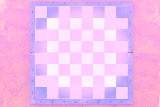 a square board divided into sixty-four alternating dark and light squares, used for playing chess or checkers. Purple pink white chessboard on a pink marble surface