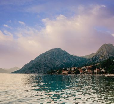 Sunset, beautiful landscape with silhouettes of trees. Travel concept. Montenegro, Kotor Bay. Sunset at Kotor Bay Montenegro. View of the sunset in Boko-Kotor Bay in Montenegro. Silhouettes of mountains. High quality photo