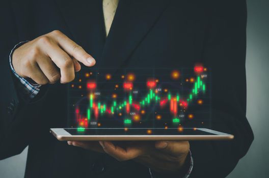 Finance and business investment concept. Stock and crypto investment funds.Businessman analyzing or trading Forex graphs of financial data candlestick chart.