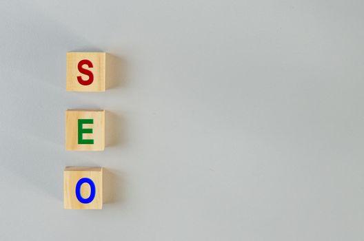 wooden cubes for SEO Search engine optimization  on gray background.Copy space.