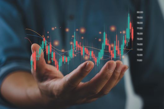 Finance and business investment concept. Stock and crypto investment funds.Businessman analyzing or trading Forex graphs of financial data candlestick chart.