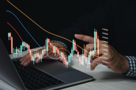 Finance and business investment concept. Stock and crypto investment funds.Businessman analyzing or trading Forex graphs of financial data candlestick chart.