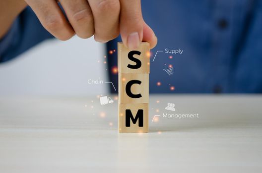 Hand put wooden cubes SCM Supply Chain Management .Business marketing Concept