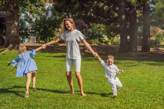 Happy family outdoors on the grass in a park, smiling faces, having fun.