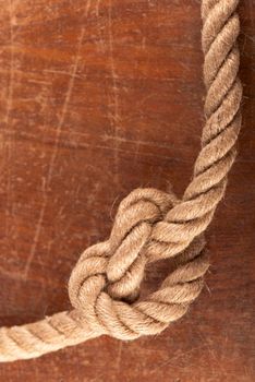 Rope with Reef Knot on Wood Texture