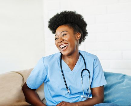 Portrait of a young female nurse caregiver in a nursing home or visit in household