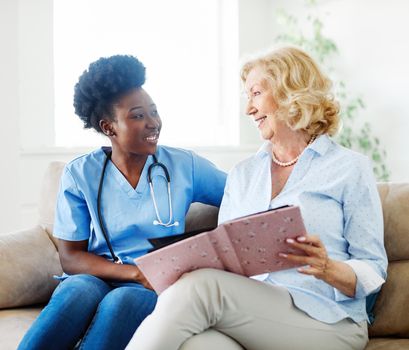 Doctor or nurse caregiver with senior woman at home or nursing home