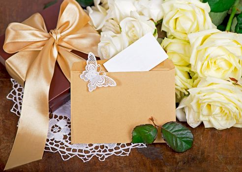 bouquet of white rose with green leaves on a wooden