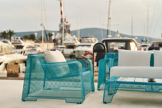 Wicker blue chair, sofa and table. Summer outdoor furniture on the seashore. High quality photo