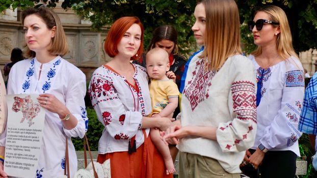 Rally of Ukrainians people, woman, mom with baby against the war in Ukraine on the day of embroidery. Edutorial Italy, Milan 19.05.2022.