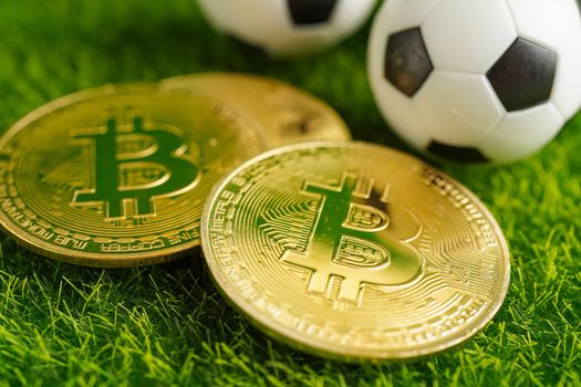 Gold bitcoin with soccer ball or football, cryptocurrency used in online sports betting.