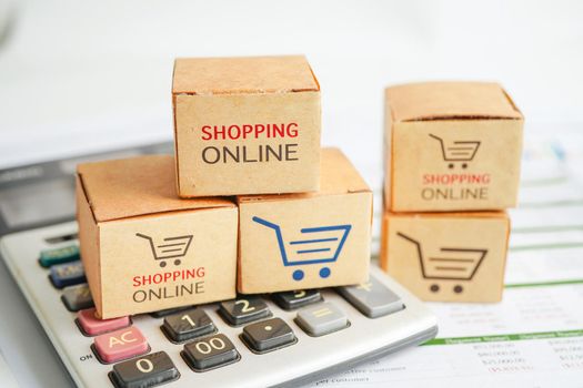 Online shopping, Shopping cart box on calculator, import export, finance commerce.