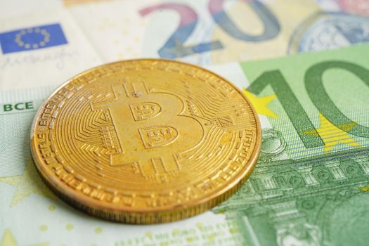 Golden bitcoin on Euro banknotes money for business and commercial, Digital currency, Virtual cryptocurrency.
