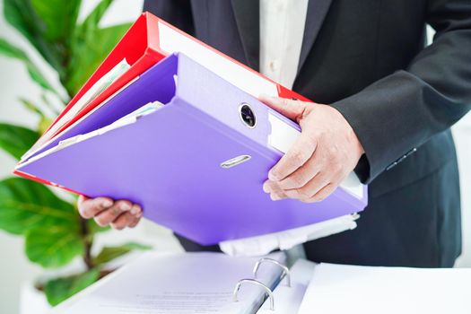 Businessman working and prepare paperwork report data to analysis information in file binder at office.
