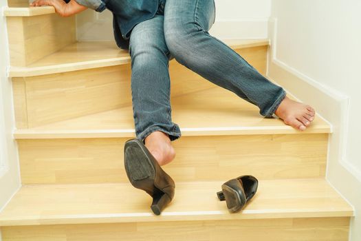 Asian business woman pain ankle, foot with leg cramp and fall down the stairs because slippery surfaces in office.