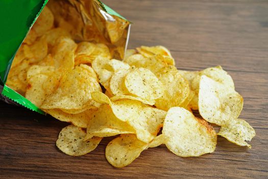 Potato chips in open bag, delicious BBQ seasoning spicy for crips, thin slice deep fried snack fast food in open bag.