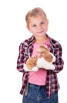 Little girl holding a toy hare. Isolated on white background. Girl hugging toy hare.