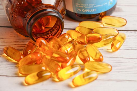 Fish oil or Cod liver oil gel in capsules with omega 3 vitamins, supplementary healthy food 