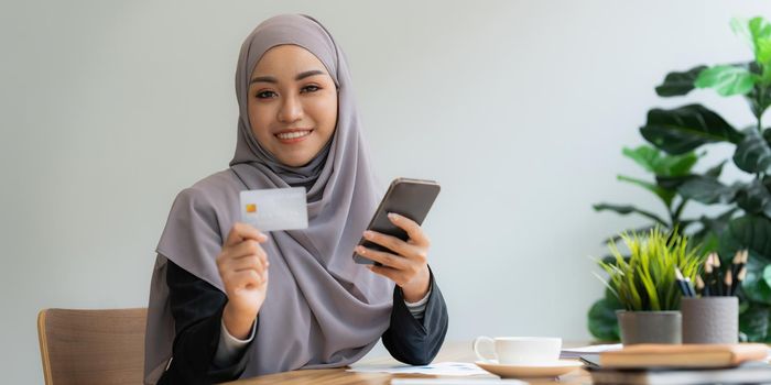 Young woman making online banking to payment with credit card and smartphone. Online Shopping concept