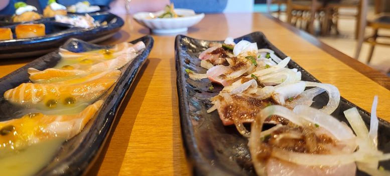 japanese food dish in an oriental restaurant with wooden table and light background