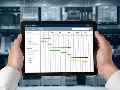 Project planning software for modish business project management on the computer screen showing timeline chart of the team project