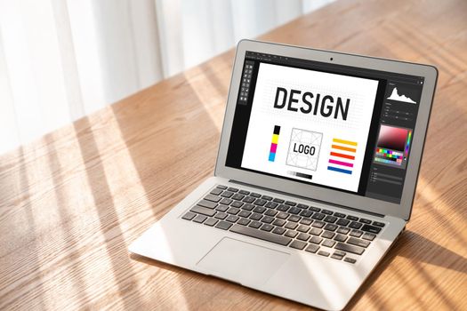 Graphic designer software for modern design of web page and commercial ads showing on the computer screen