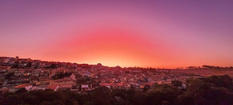 colorful late afternoon sunset in the countryside of Brazil inserting the day