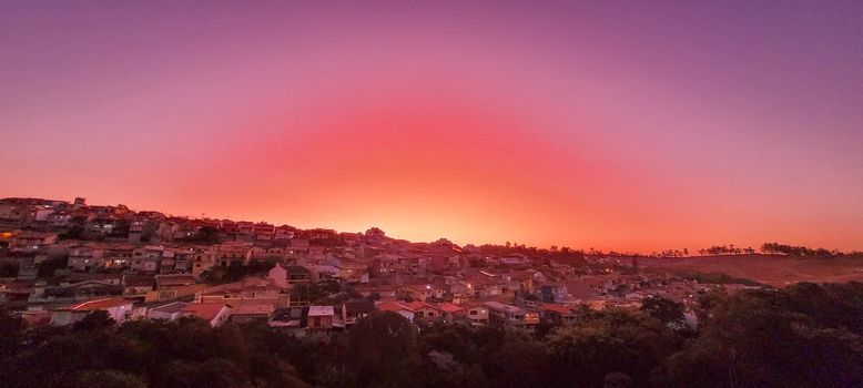 colorful late afternoon sunset in the countryside of Brazil inserting the day