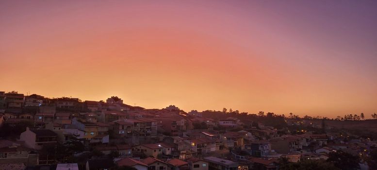 colorful late afternoon sunset in the countryside of Brazil inserting the day