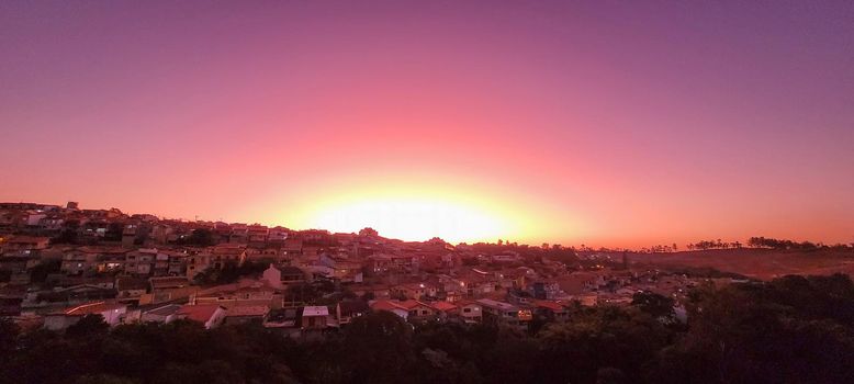 colorful late afternoon sunset in the countryside of Brazil inserting the day