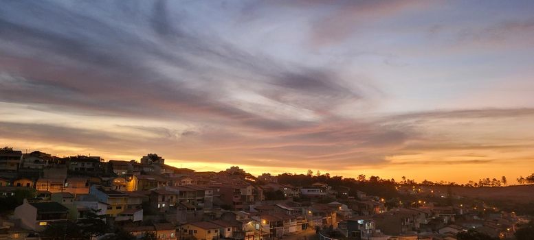 colorful late afternoon sunset in the countryside of Brazil inserting the day