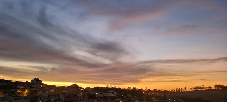 colorful late afternoon sunset in the countryside of Brazil inserting the day