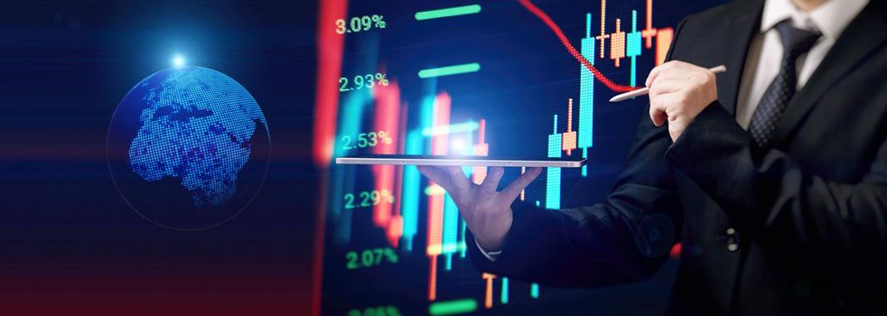 Businessman holding stock tablet ,virtual technical investment graph chart for analysis stock market , Banking financial and planing concept.