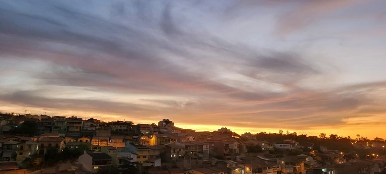 colorful late afternoon sunset in the countryside of Brazil inserting the day