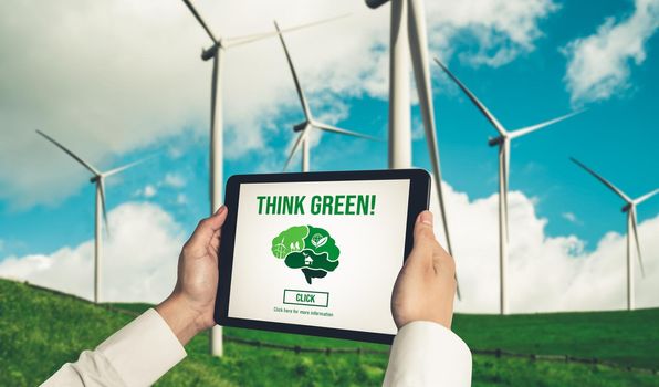 Green business transformation for environment saving and ESG business concept. Businessman using tablet to set corporate goal toward environmental friendly management and alternative clean energy use.