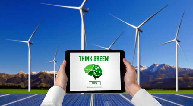 Green business transformation for environment saving and ESG business concept. Businessman using tablet to set corporate goal toward environmental friendly management and alternative clean energy use.