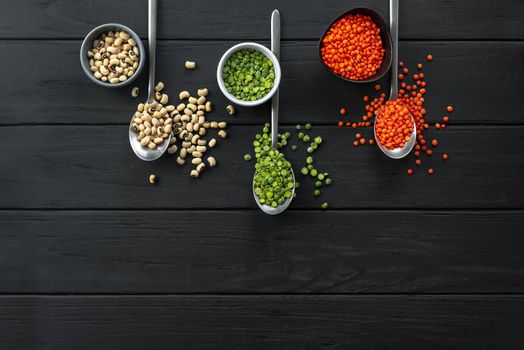 Superfood. Healthy, gluten-free meals. Lentils on spoon on a rustic dark wooden background. A set of useful Ancient grain foods on spoons on a dark background. An alternative to basic cereals. Flat lay