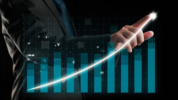 Businessman draw finance allusive graph chart showing business profit growth increasing to future target . Excellent financial status of corporate business rise up . Finance and money technology .