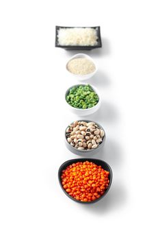 Super food on a white background in pils Ancient grain food. Rice lentils amaranth beans. Top view