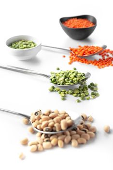 Beans on a spoon on a white background. A set of superfood cereals. Healthy eating and Ancient grain food