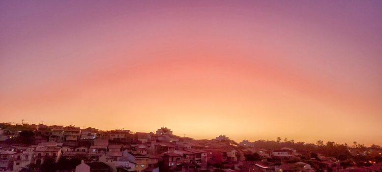 colorful late afternoon sunset in the countryside of Brazil inserting the day