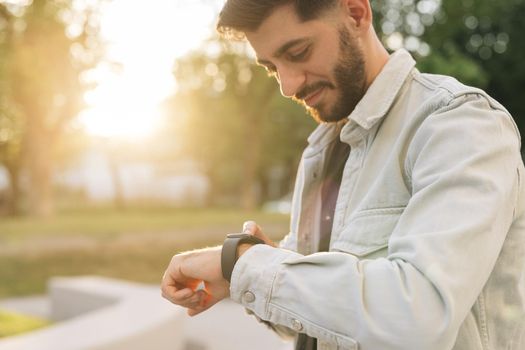 Bearded Man Using Smart Watch Wearable Wristband Device. Male Checking Pulse Smartwatch App. Touch Screen Wearable Technology Smart Band. Businessman Scrolling On Display On Smartwatch Notification.