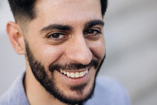 Smiling caucasian young bearded man in formal outfit looking to camera outside on street feel happy businessman portrait business modern manager pretty.